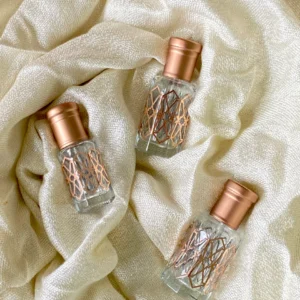 bottles of gold-tier misk/musk on a silky cloth